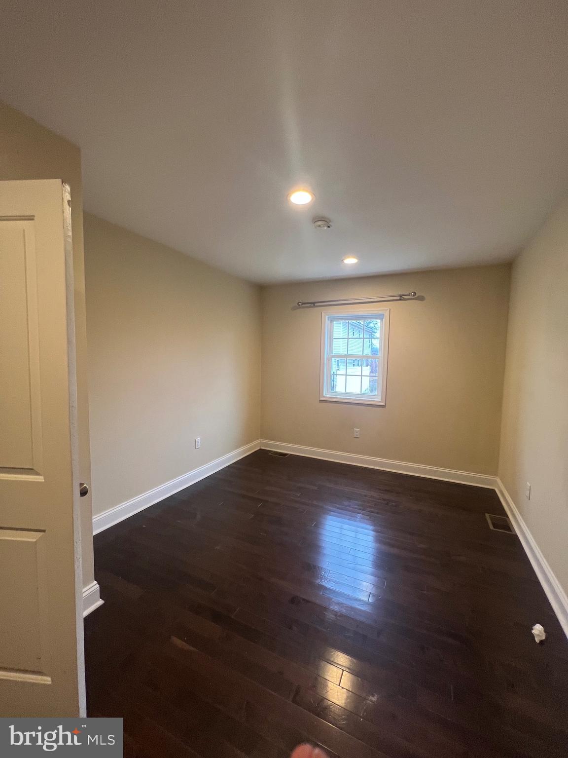 4243 Dix Street Northeast Washington, DC 20019 - Photo 14 of 43 an empty room with wooden floor and windows