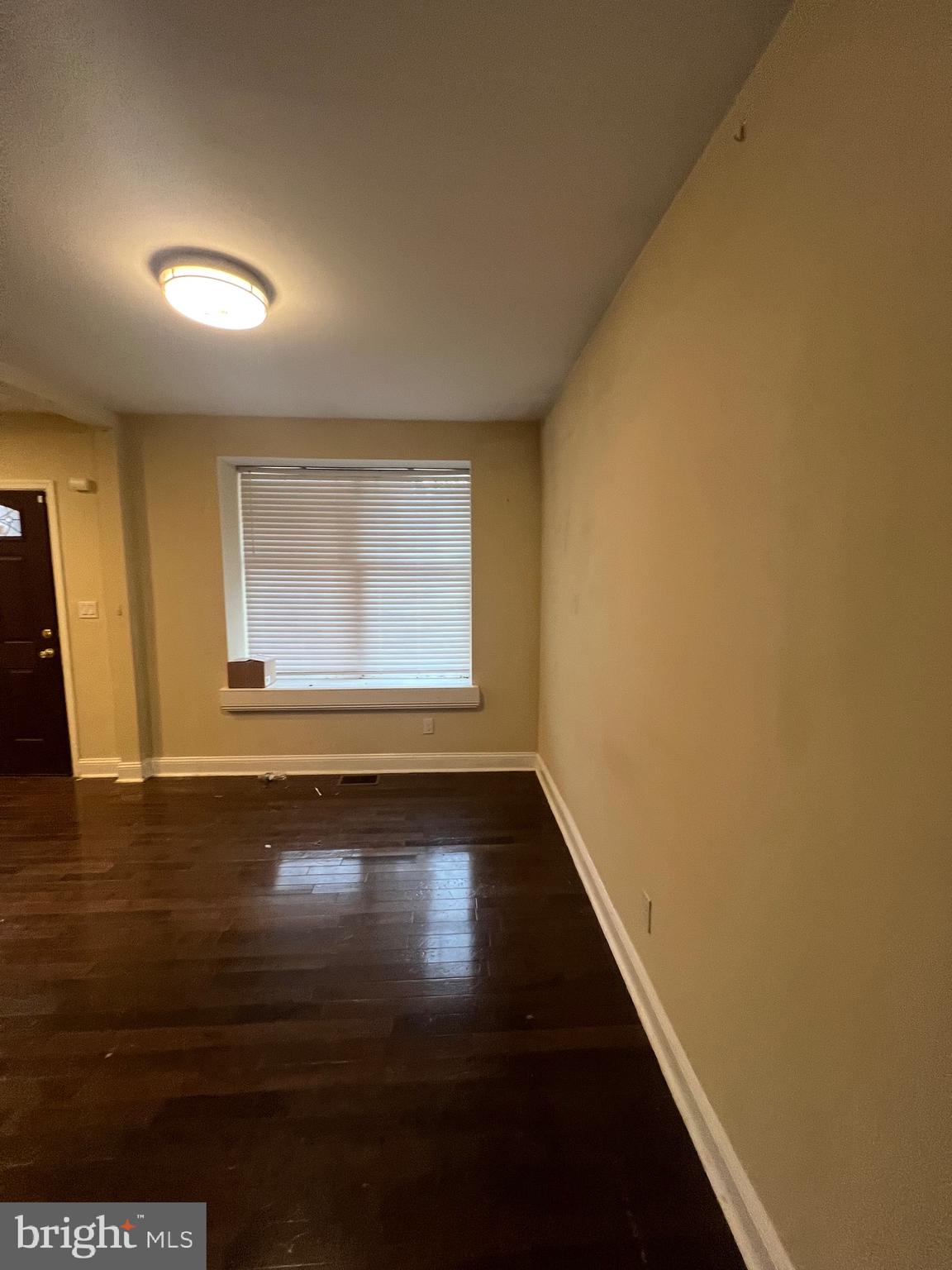 4243 Dix Street Northeast Washington, DC 20019 - Photo 24 of 43 a view of an empty room with wooden floor and a window