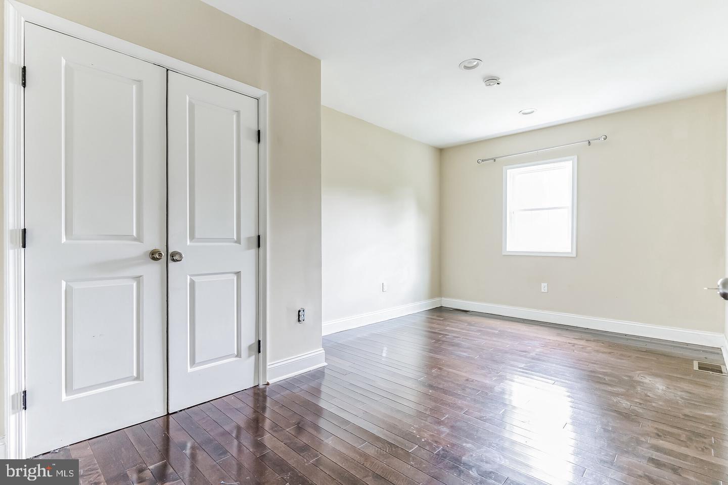 4243 Dix Street Northeast Washington, DC 20019 - Photo 35 of 43 an empty room with wooden floor and window