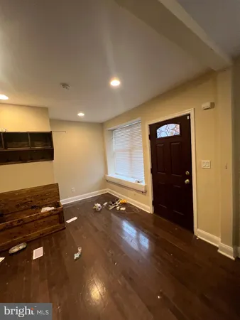 a view of a room with gym equipment and wooden floor