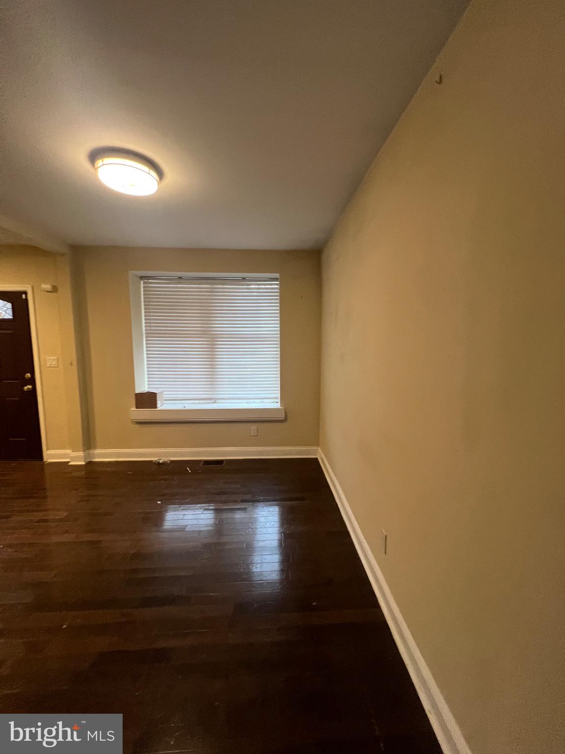 4243 Dix Street Northeast Washington, DC 20019 - Photo 7 of 43 a view of an empty room with wooden floor and a window
