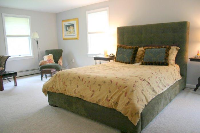65 East Hubbard Road Sandisfield, MA 01255 - Photo 22 of 26 a bed sitting in a bedroom next to a window and a chair