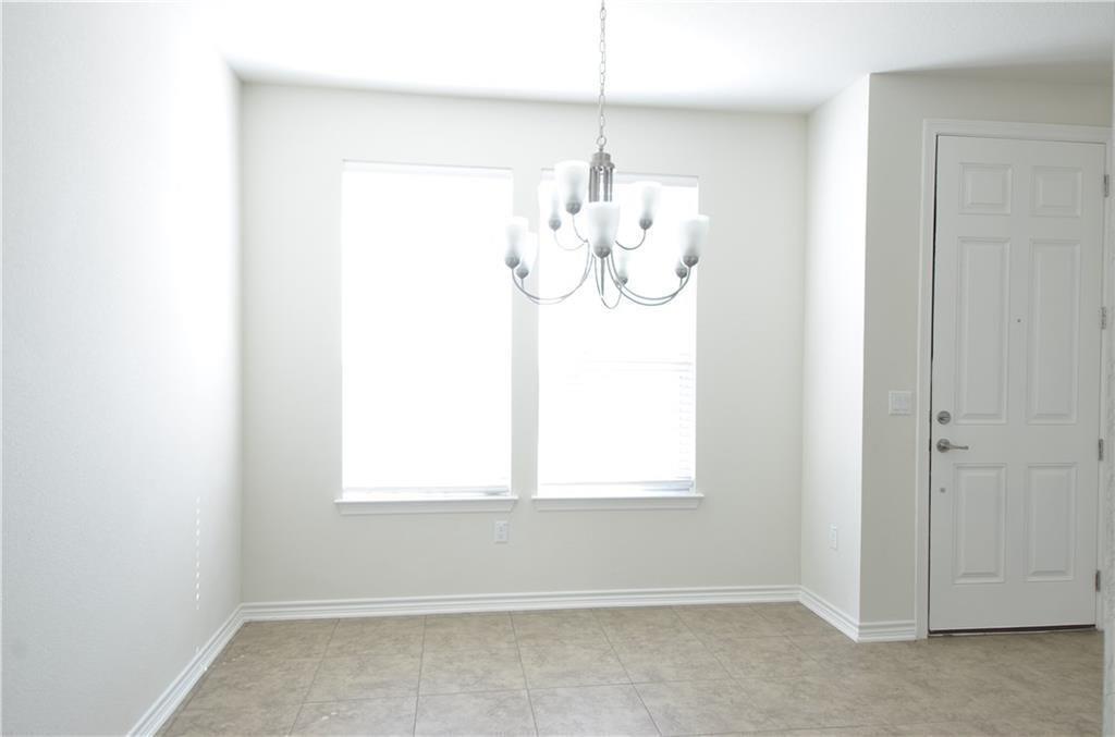 14403 McCoy Loop Austin, TX 78717 - Photo 5 of 29 A refined ceiling fixture illuminates this elegant dining area, perfectly positioned by ample window light.