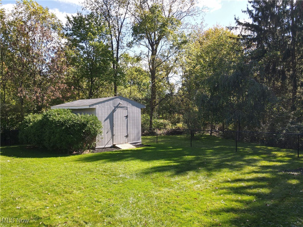 35600 Bainbridge Road Solon, OH 44139 - Photo 16 of 18 View of fully fenced yard featuring a storage shed