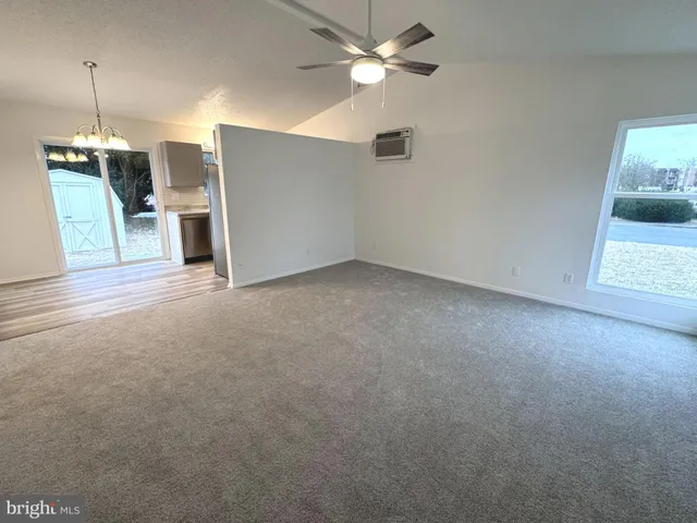 a view of a livingroom with a ceiling fan a flat screen tv and a ceiling fan