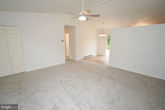 a view of an empty room with a ceiling fan