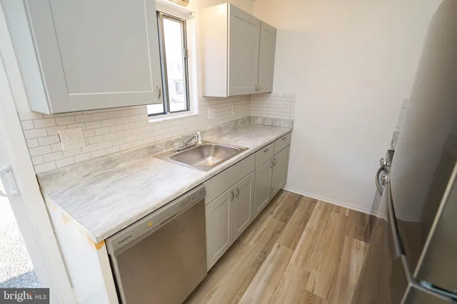 a kitchen with a sink stove and cabinets
