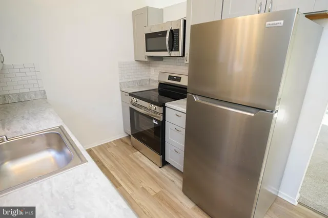 a kitchen with a refrigerator and a sink