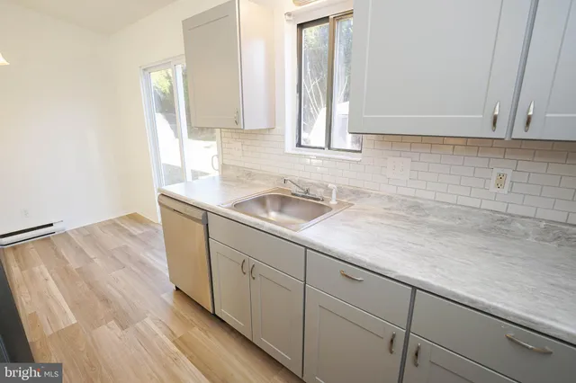 a kitchen with a sink and cabinets