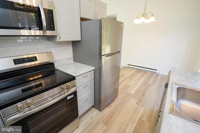 a kitchen with appliances and cabinets