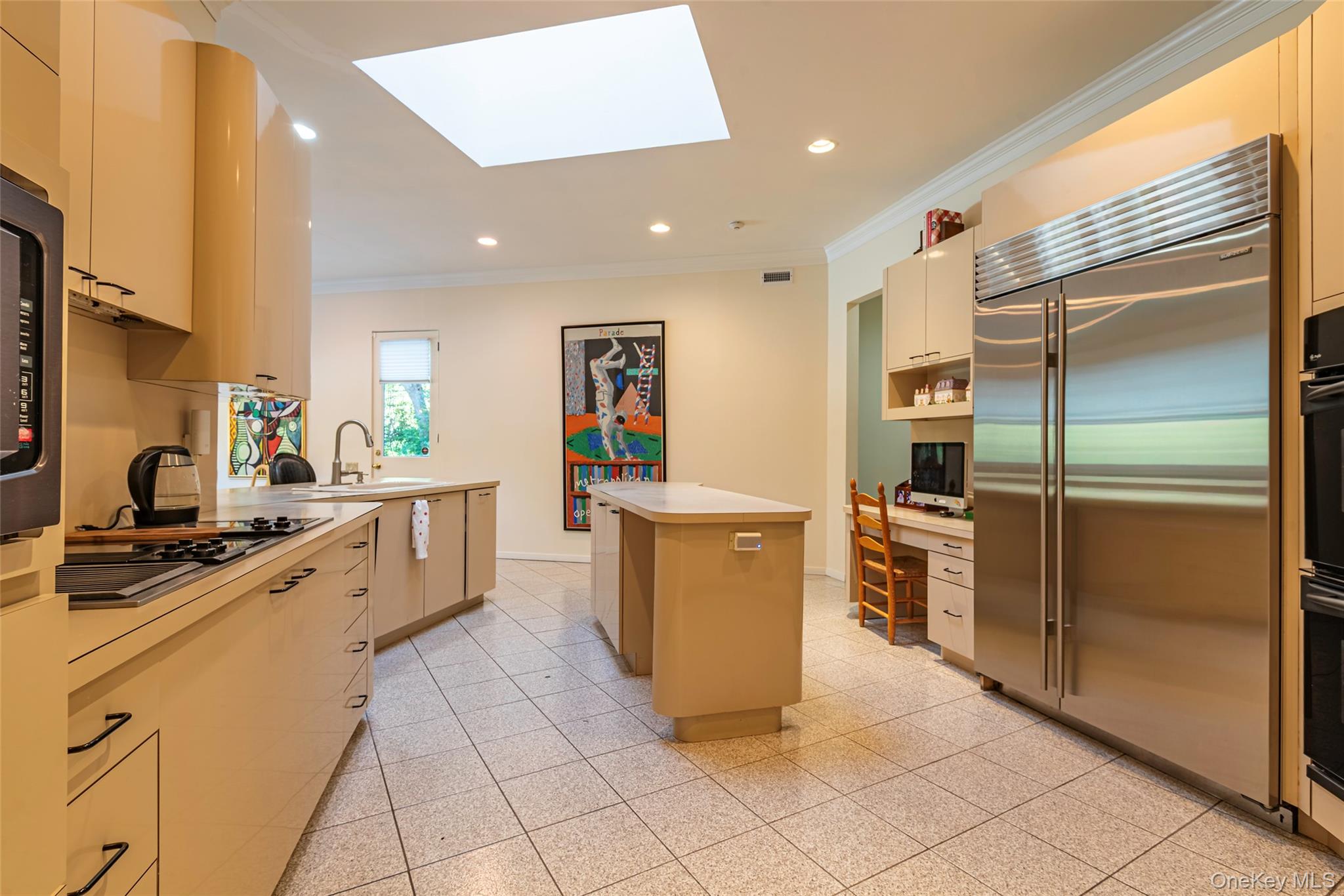 735 Remsens Lane Upper Brookville, NY 11771 - Photo 14 of 44 Kitchen with ornamental molding, a skylight, black appliances, a kitchen island, and light countertops