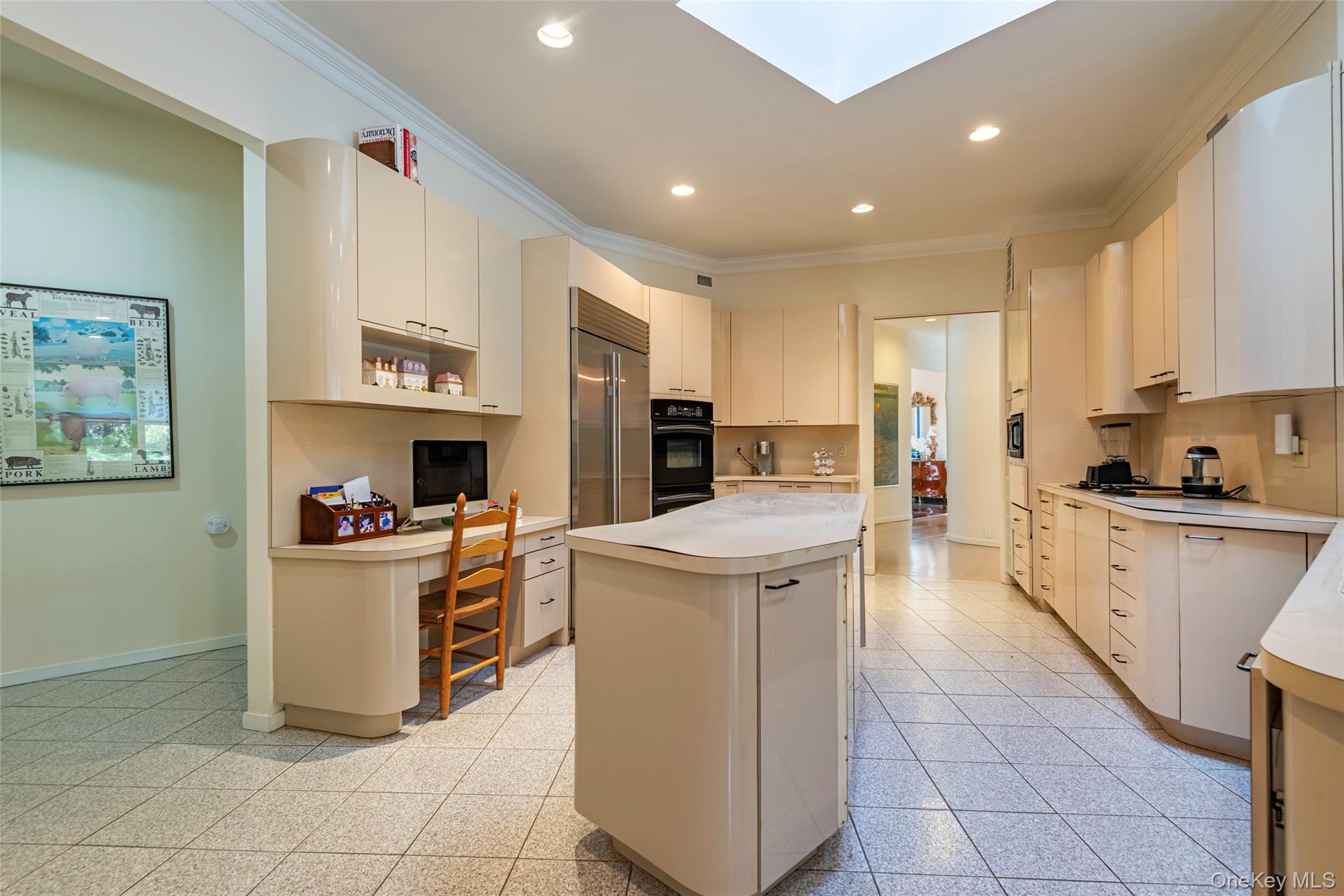 735 Remsens Lane Upper Brookville, NY 11771 - Photo 16 of 44 Kitchen with crown molding, light countertops, a skylight, recessed lighting, and a kitchen island
