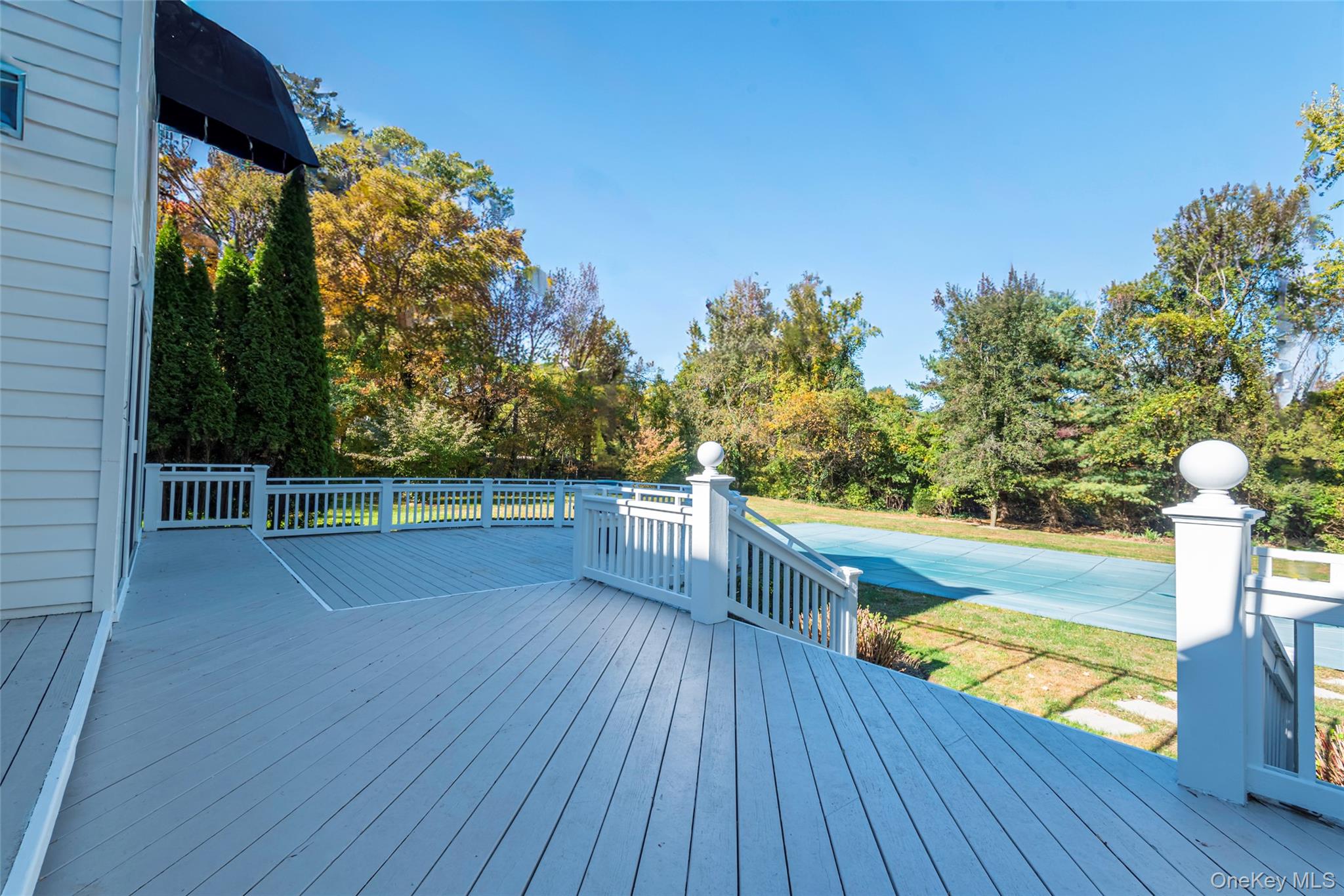735 Remsens Lane Upper Brookville, NY 11771 - Photo 35 of 44 Deck featuring a lawn and a swimming pool
