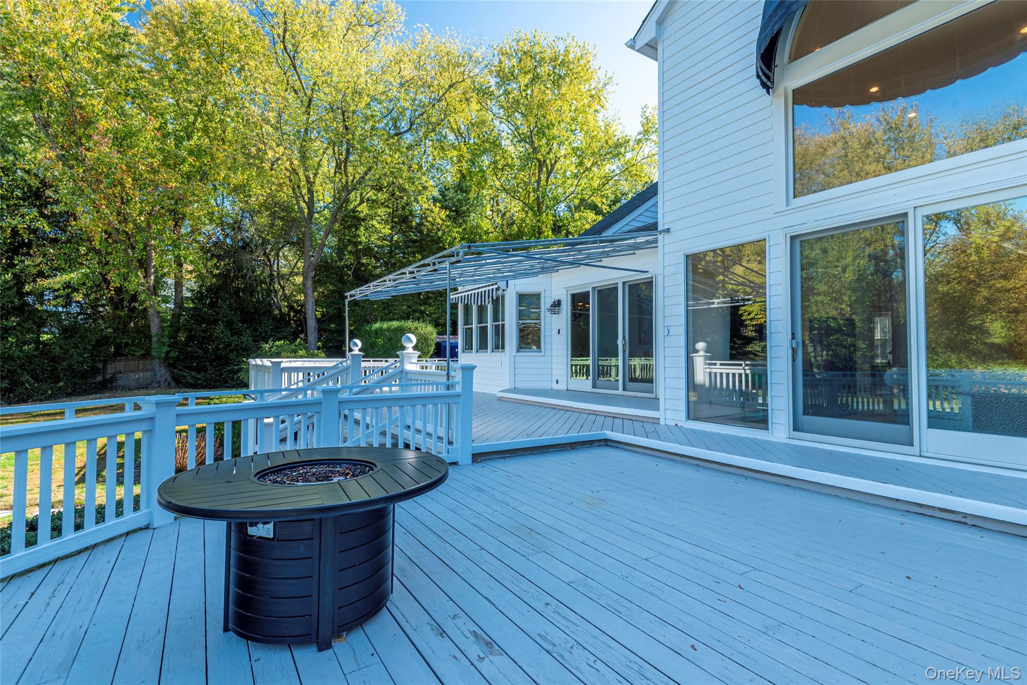 735 Remsens Lane Upper Brookville, NY 11771 - Photo 37 of 44 Wooden terrace with a fire pit and view of wooded area