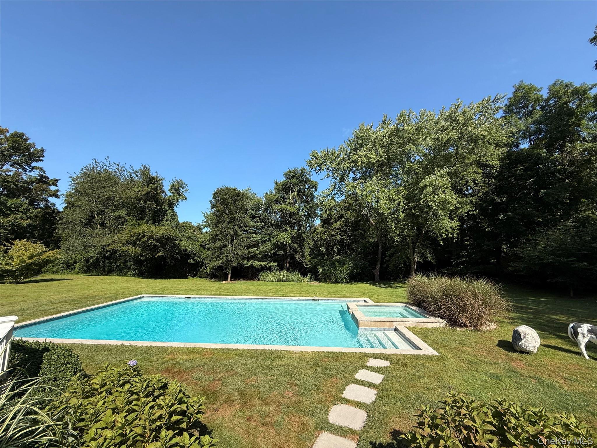 735 Remsens Lane Upper Brookville, NY 11771 - Photo 38 of 44 View of swimming pool with a lawn, a patio area, and a pool with connected hot tub