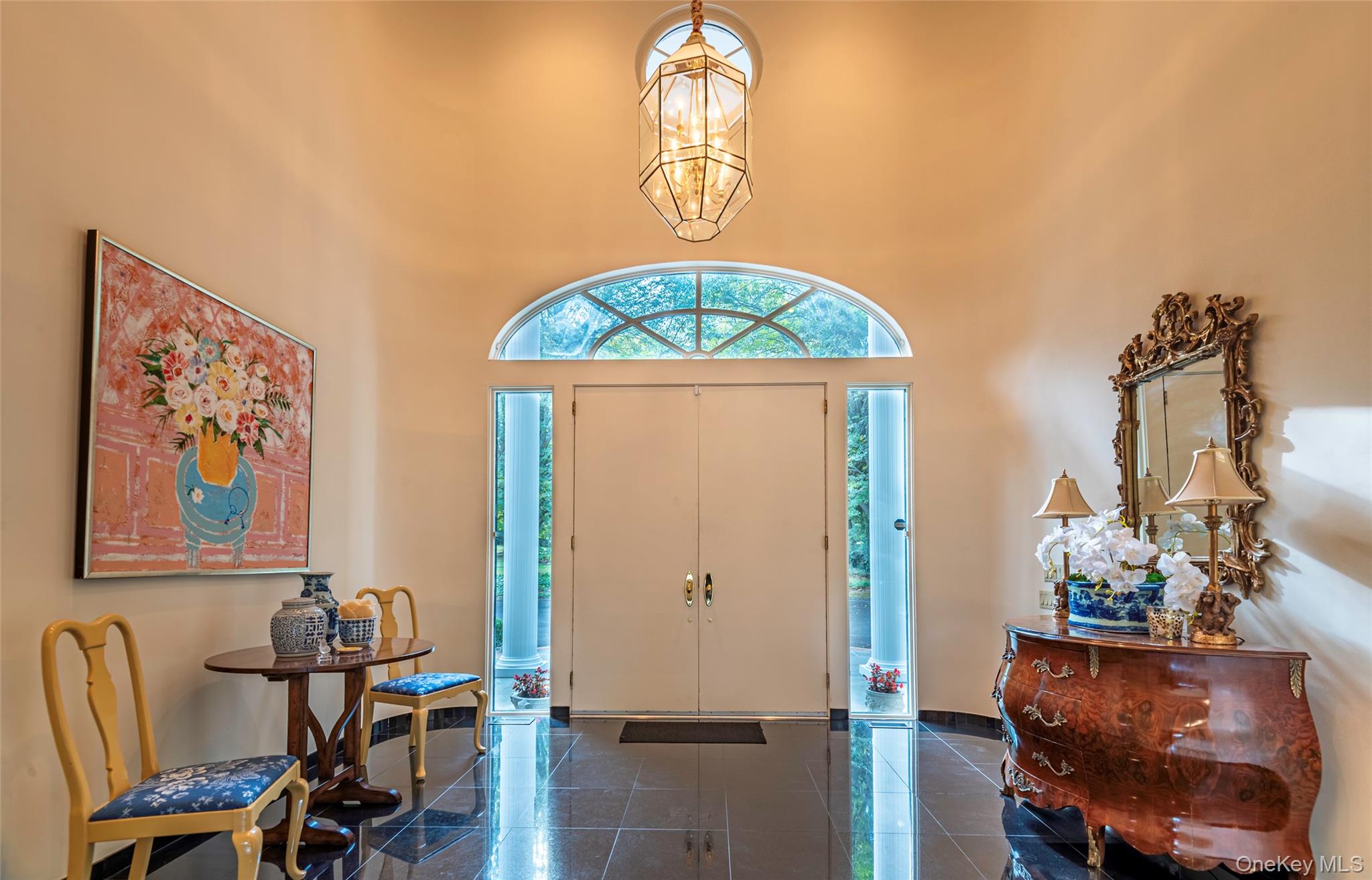 735 Remsens Lane Upper Brookville, NY 11771 - Photo 4 of 44 Entryway featuring a chandelier, a high ceiling, and granite tiled floors
