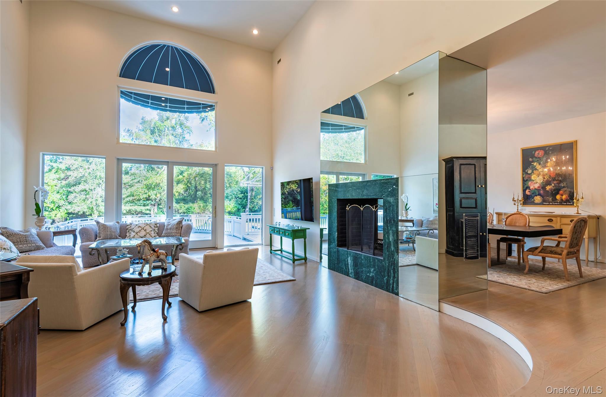 735 Remsens Lane Upper Brookville, NY 11771 - Photo 7 of 44 Living room with a high ceiling, wood finished floors, and a fireplace