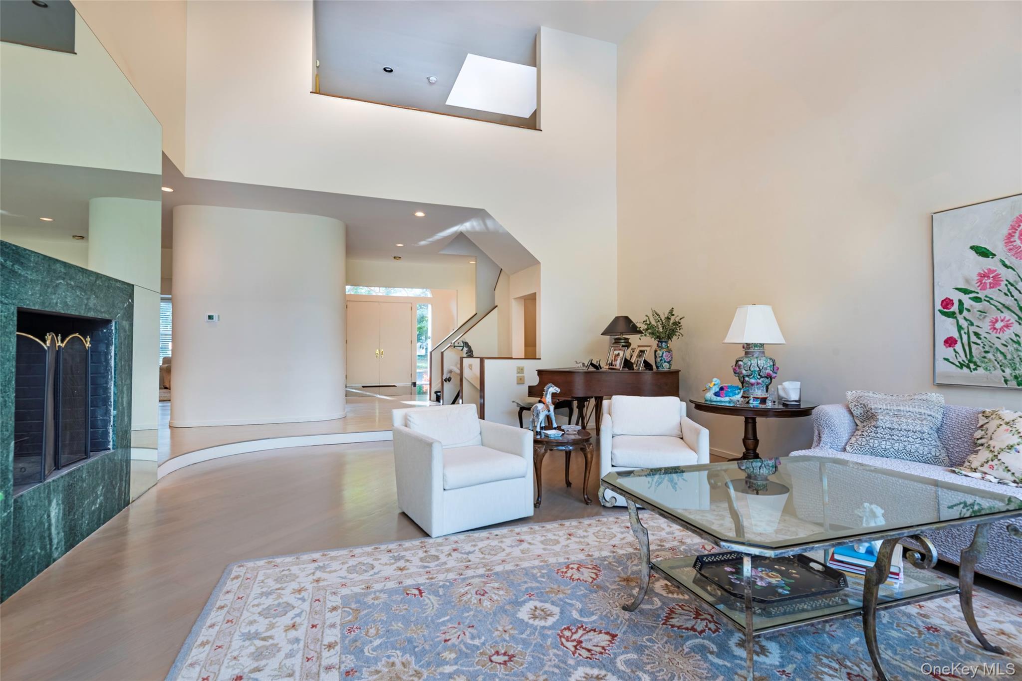 735 Remsens Lane Upper Brookville, NY 11771 - Photo 9 of 44 Living area with a high ceiling, a tiled fireplace, and stairs