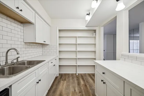 a kitchen with a sink cabinets and appliances
