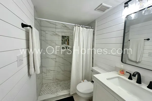 a bathroom with a shower and a sink