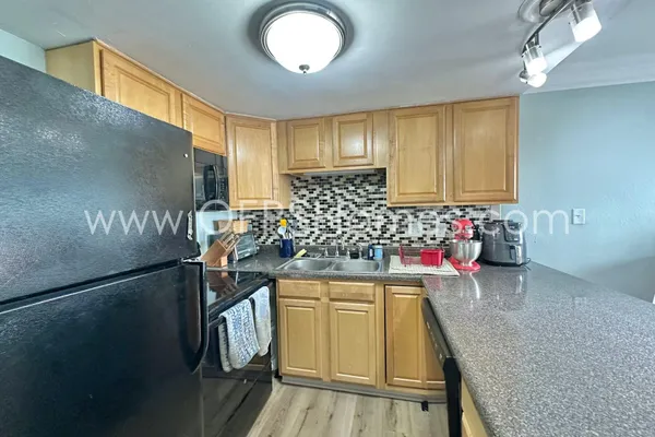 a kitchen with a sink and cabinets