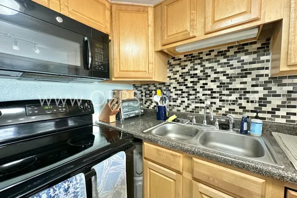 a kitchen with a sink and cabinets