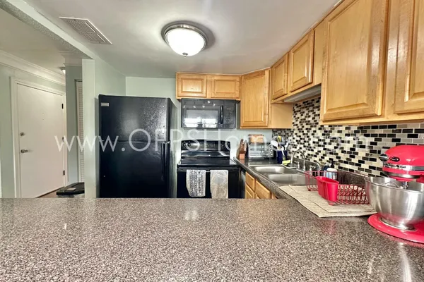 a kitchen with a refrigerator and window