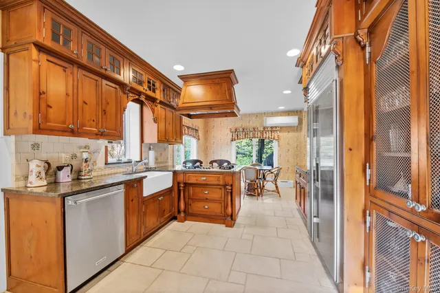 a kitchen with stainless steel appliances granite countertop a refrigerator and a stove top oven