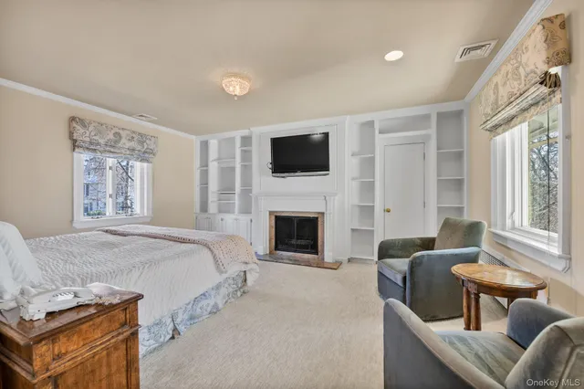 a spacious bedroom with a balcony a bed and a flat screen tv