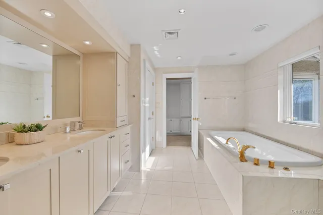 a spacious bathroom with a granite countertop sink and a mirror