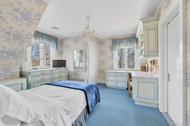 a bedroom with furniture and a window