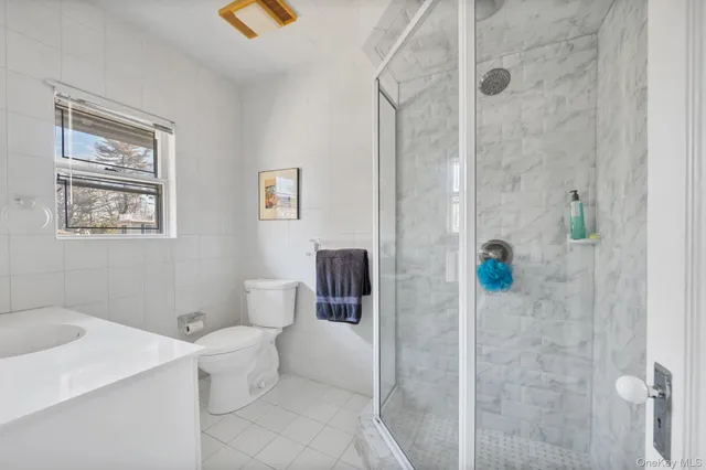 a bathroom with a toilet sink and shower