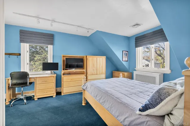 a bedroom with a bed and a chair