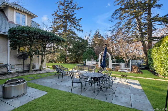 a view of a house with backyard sitting area and garden