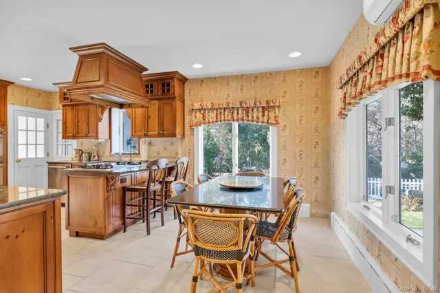 a dining room with furniture a window and a kitchen view