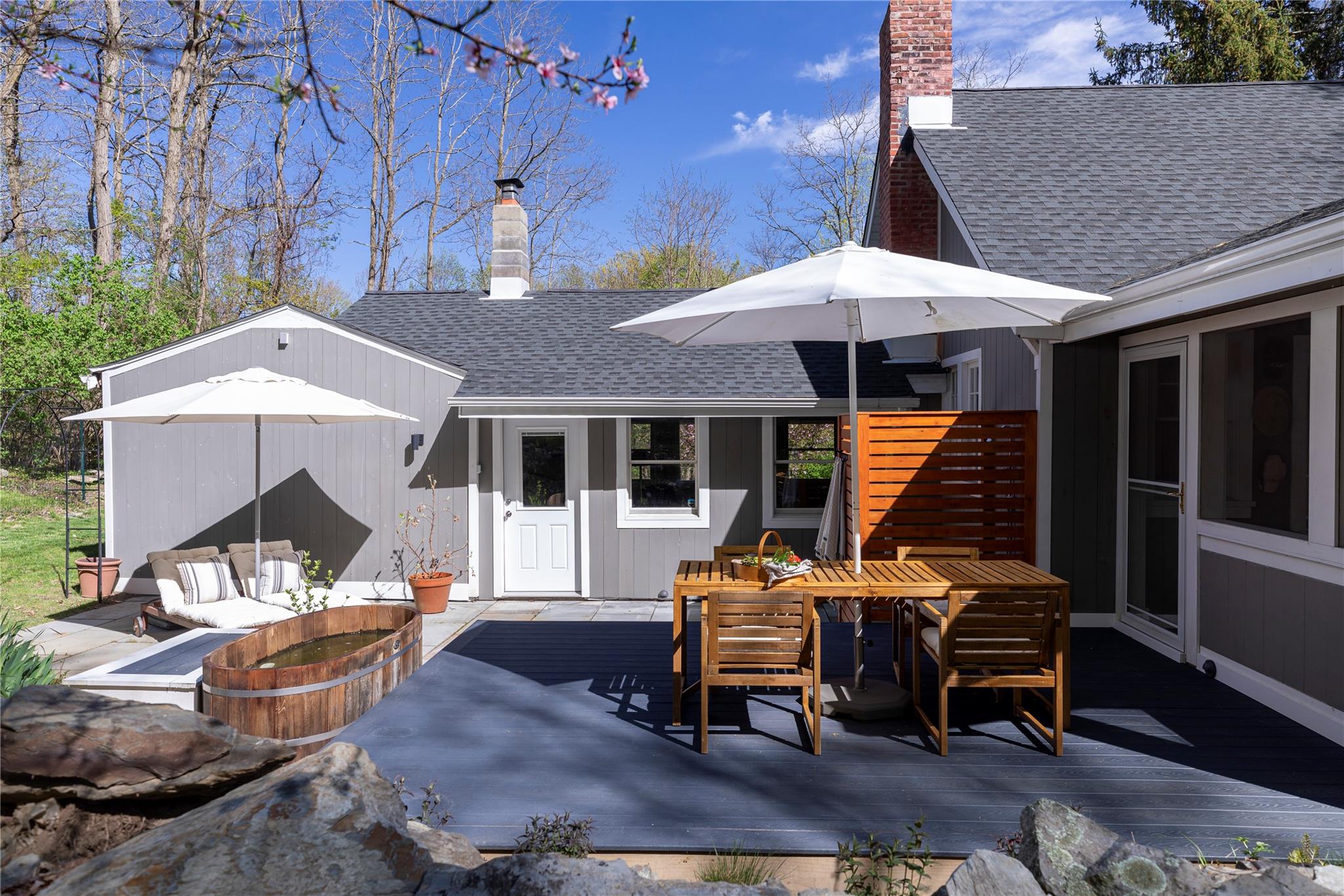 161 Camp Road Red Hook, NY 12571 - Photo 1 of 1 Back of house with a shingled roof, a chimney, a deck, and outdoor dining space