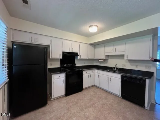 a kitchen with a sink stainless steel appliances and cabinets
