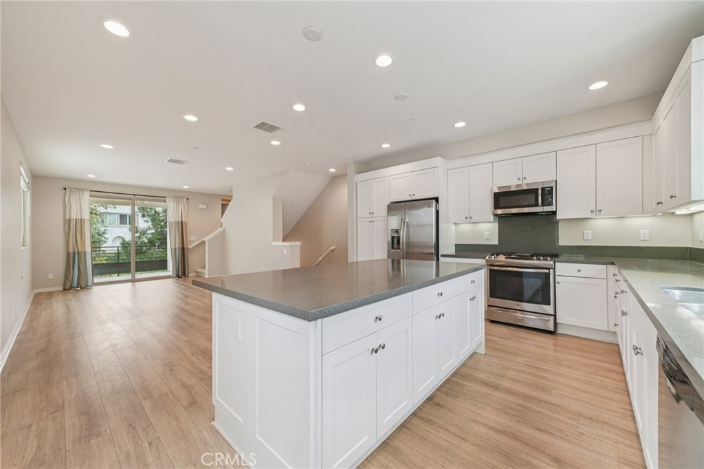 143 Frame Irvine, CA 92618 - Photo 5 of 41 a large kitchen with stainless steel appliances granite countertop a large counter top and a stove top oven