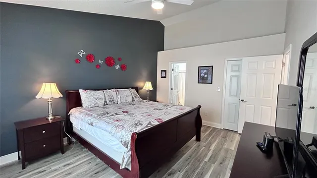 a bedroom with a bed and a chandelier
