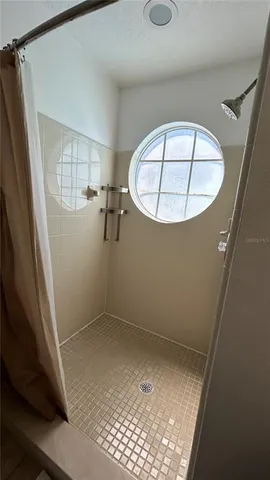 an empty room with a wooden floor and white walls