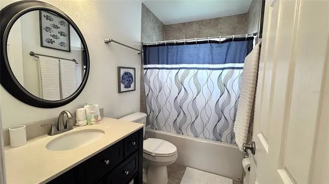 a bathroom with a toilet a sink and a mirror