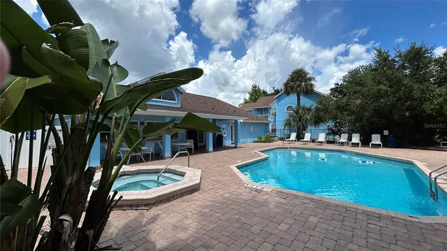 a view of swimming pool with a table and chairs