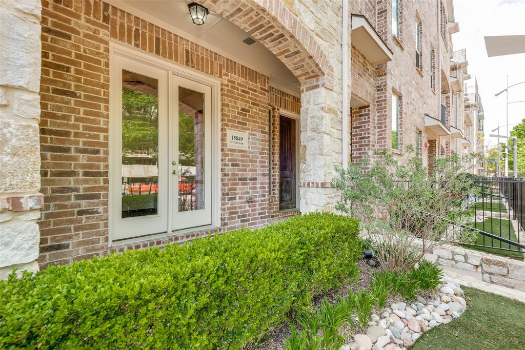 15849 Spectrum Drive Addison, TX 75001 - Photo 1 of 1 a view of a brick house with a large window and a yard with plants