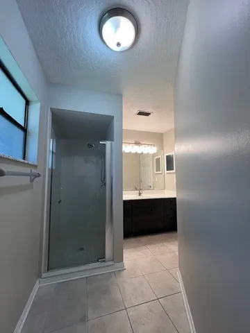 a bathroom with a tub shower and sink