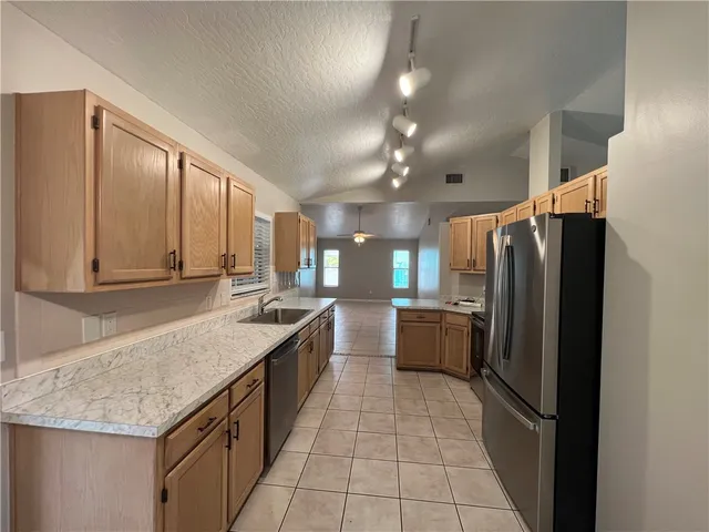 a kitchen with a refrigerator and countertop