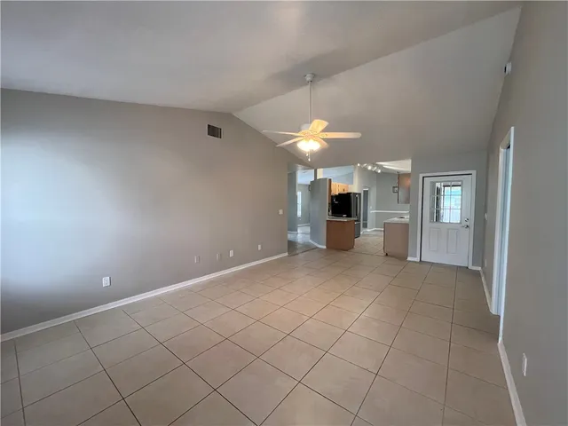 an empty room with fireplace and windows