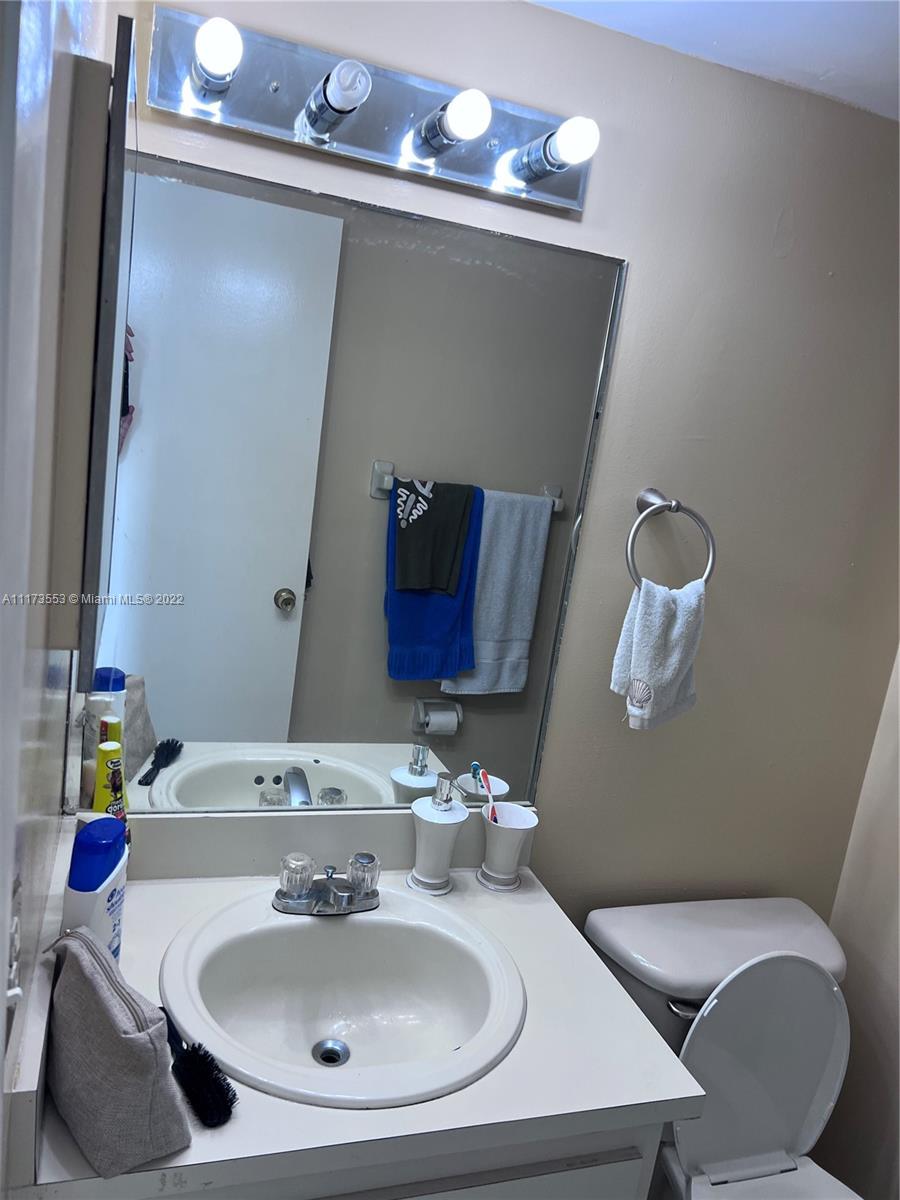 2075 Southwest 122nd Avenue, Unit 320 Miami, FL 33175 - Photo 16 of 38 a bathroom with a sink and a mirror