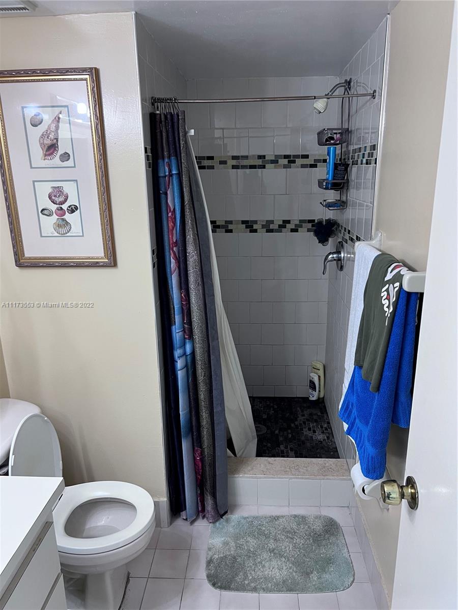 2075 Southwest 122nd Avenue, Unit 320 Miami, FL 33175 - Photo 17 of 38 a bathroom with a toilet and a shower