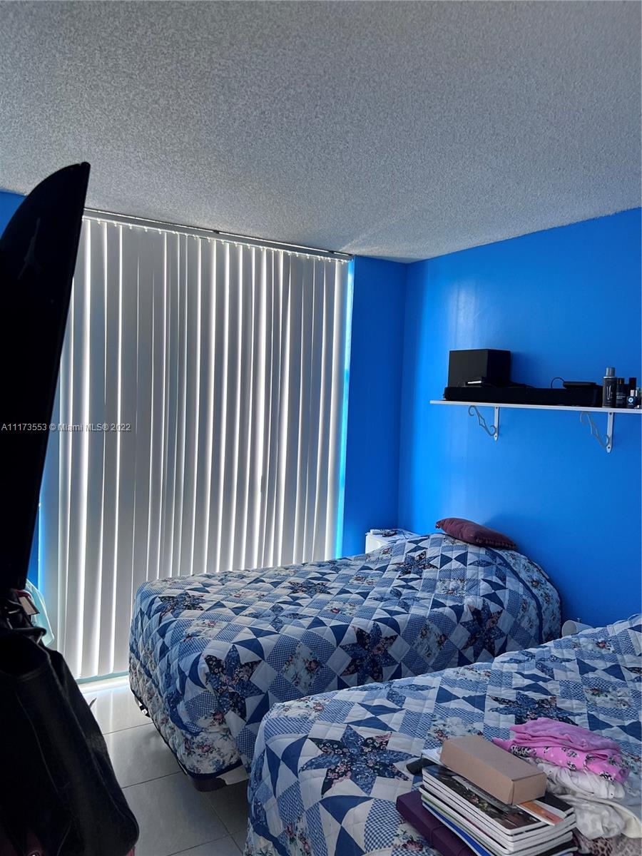 2075 Southwest 122nd Avenue, Unit 320 Miami, FL 33175 - Photo 20 of 38 a bedroom with a bed and a dresser