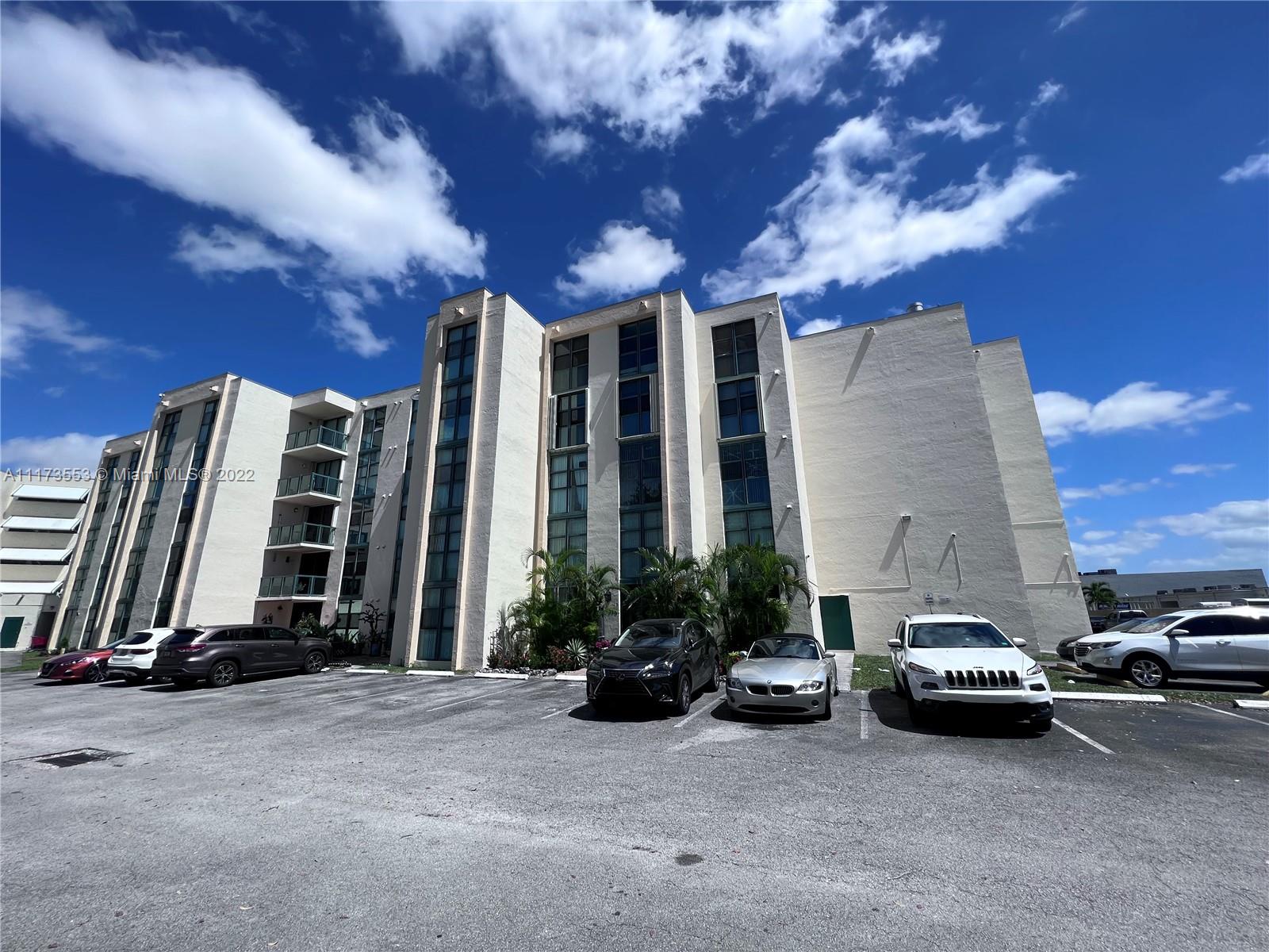 2075 Southwest 122nd Avenue, Unit 320 Miami, FL 33175 - Photo 35 of 38 a view of a cars park in front of a house